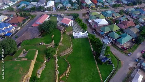 Aerial view rising away from the Acropolis Park, during golden hour, in Apo, Abuja - Pull back, tilt up, drone shot photo