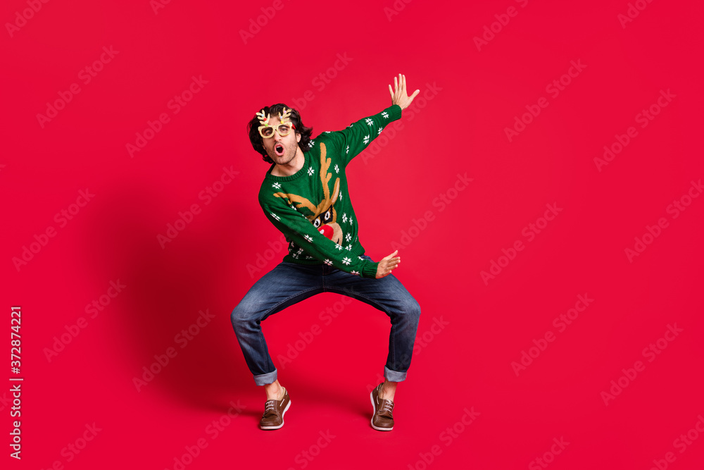Full length body size view of his he nice attractive positive cheerful cheery funny youth guy having fun dancing fooling rest christmastime isolated bright vivid shine vibrant red color background Full length body size view of his he nice attractive positive cheerful cheery funny youth guy having fun dancing fooling rest christmastime isolated bright vivid shine vibrant red color background