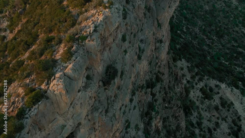 Aerial video filmed by drone of the cliffs in the west of the island of Ibiza. In front of the island of Es Vedrà. You can see the famous Pirate Tower at the end of the clip.