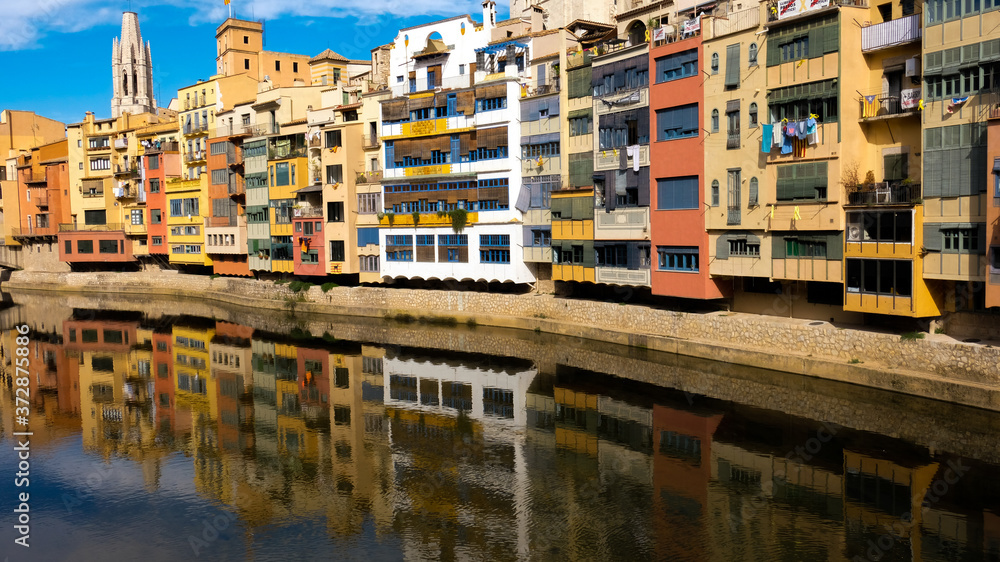 Reflection of colourful houses on girona river