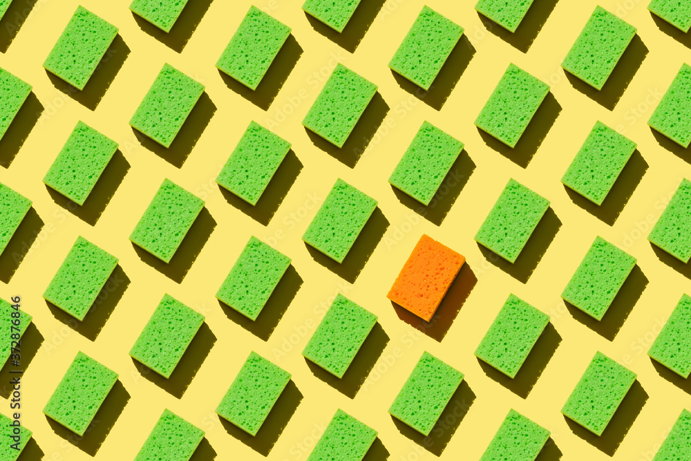 Seamless pattern green sponges for washing dishes on a yellow background Seamless pattern green sponges for washing dishes on a yellow background