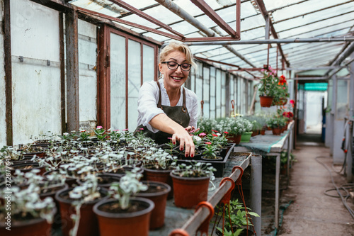 woman gardener working in greenhouse