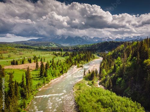 Drone photo of Bialka River with view to the Tatra Mountains- spring season with pretty colours