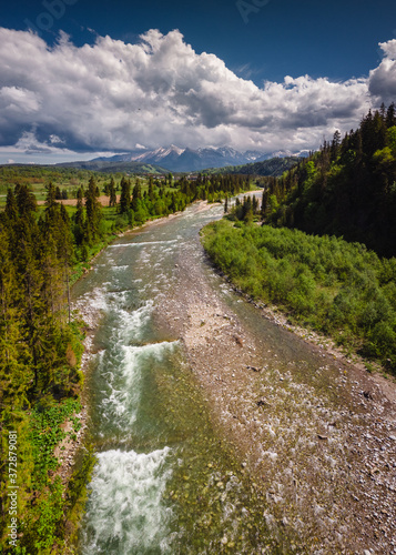 Drone photo of Bialka River with view to the Tatra Mountains- spring season with pretty colours