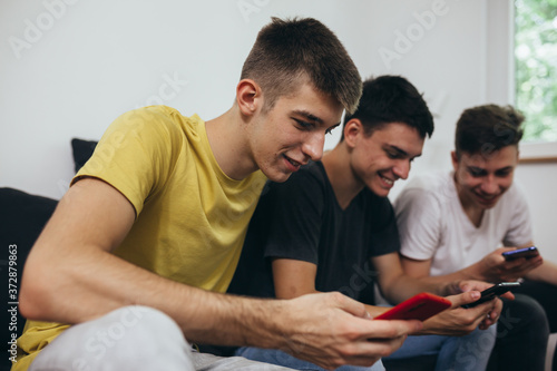 teenagers using mobile phones at home