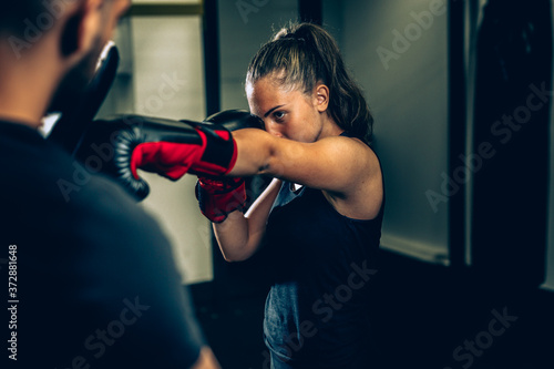 woman kick boxing or boxing training