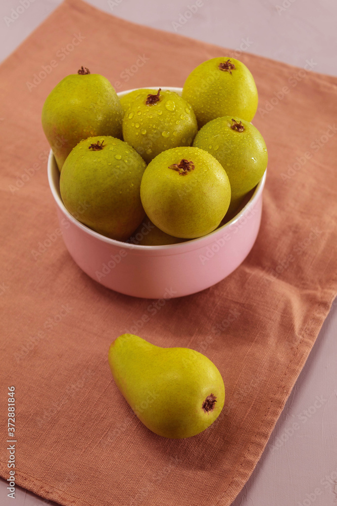 Fresh fruit is in the plate. These are little green pears from the garden Fresh fruit is in the plate. These are little green pears from the garden