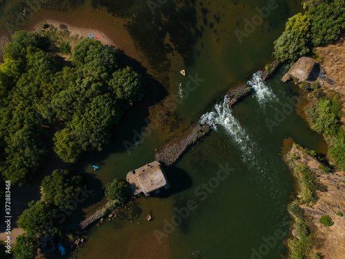 Aerial view from a river with an old water mill. Guadiana River in Portugal 