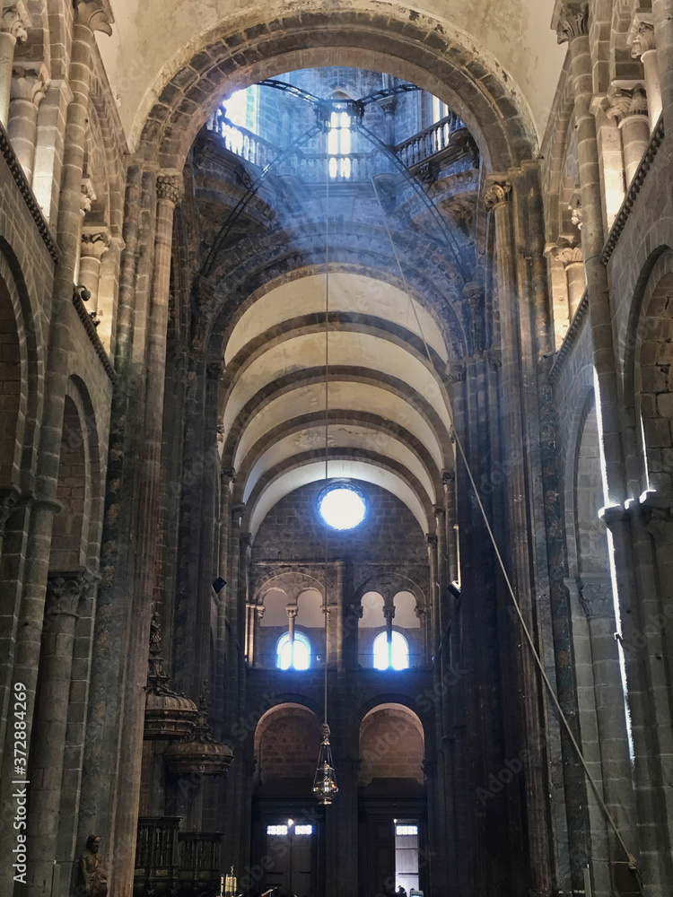 Mystic view inside the Cathedral of Santiago in Galicia, Spain. Beam of light coming through a stained glass