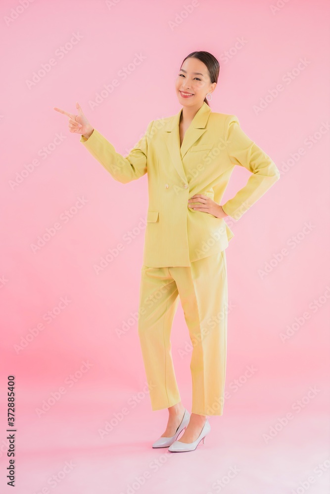 Portrait beautiful young asian business woman smile in action on pink color Portrait beautiful young asian business woman smile in action on pink color