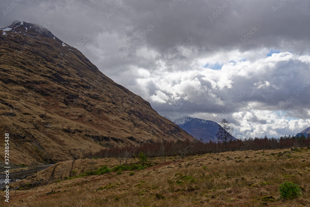 The Mountain Scenery of Glen Etive, with remnants of snow clinging to the peaks looking down over the Valley Floor in April.
