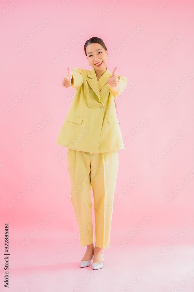 Portrait beautiful young asian business woman smile in action on pink color Portrait beautiful young asian business woman smile in action on pink color