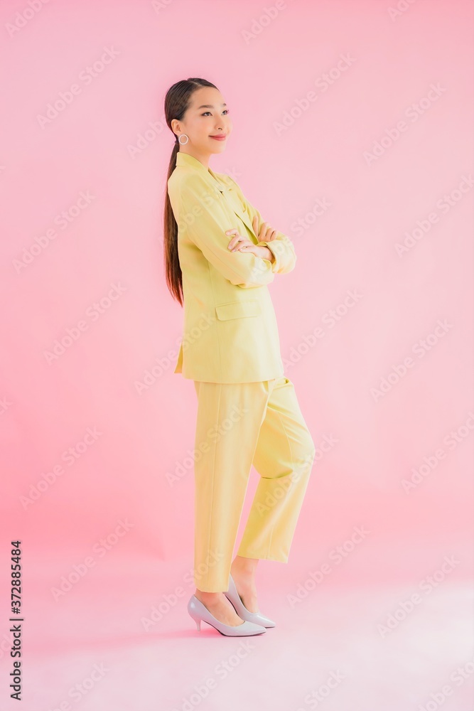 Portrait beautiful young asian business woman smile in action on pink color Portrait beautiful young asian business woman smile in action on pink color