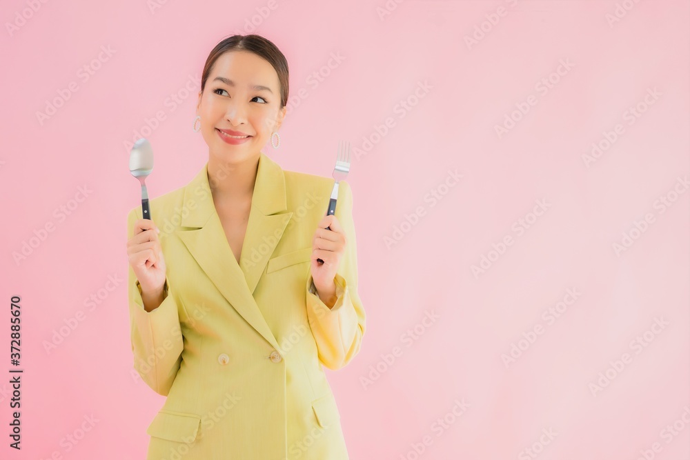 Portrait beautiful young asian business woman with spoon and fork Portrait beautiful young asian business woman with spoon and fork