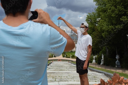 two young people taking a creative and original photograph at La Granja de San Ildefonso Palace 18th century Royal Palace in the province of Segovia in Spain photo