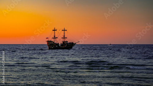 big pirate boat in the sunset sea