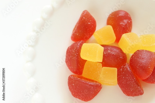 Canvastavla red and yellow gummy jelly candy on white dish