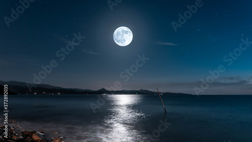 Photography Super moon over the mediterranean sea with mountains in background
