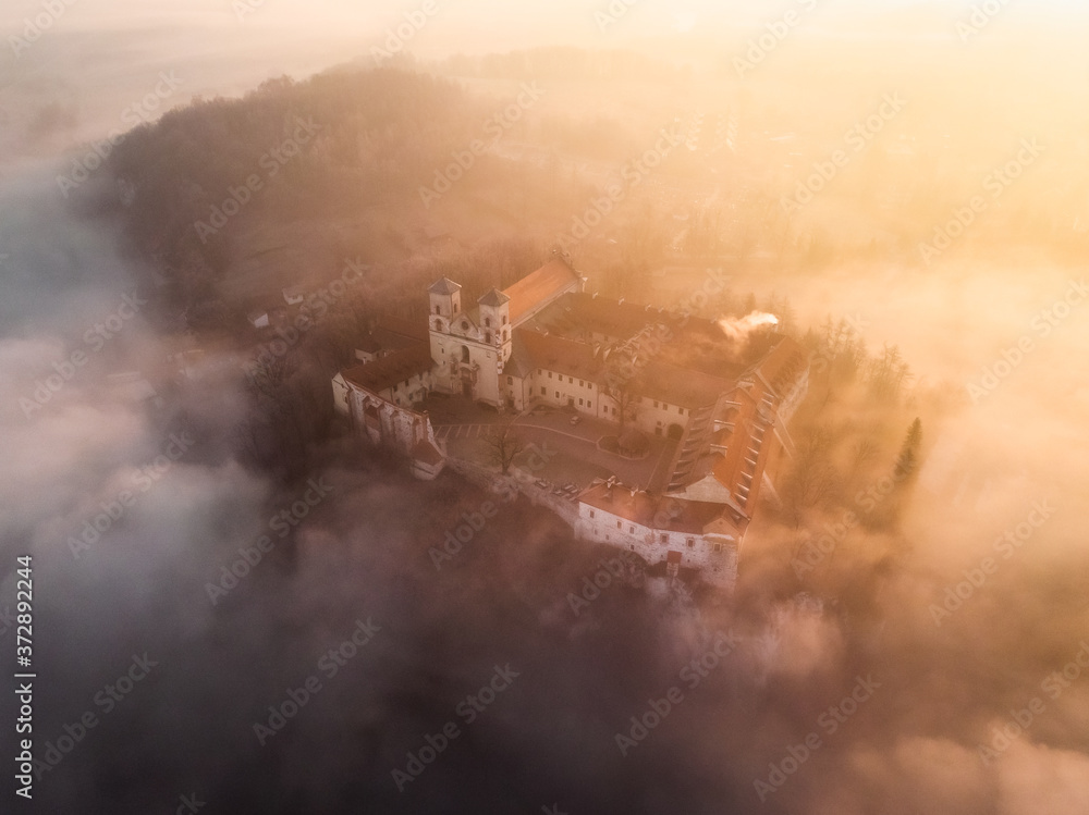 Fototapeta premium Drone aerial photo of Tyniec Abbey in mist near Krakow in Malopolska, Poland
