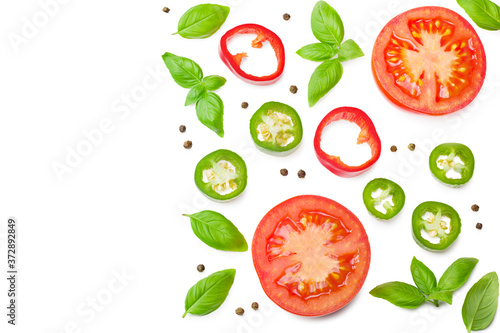 fresh tomato slices with green pepper and basil leaves isolated on white background. top view