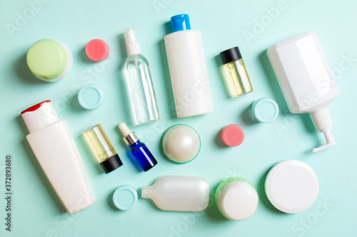 Group of plastic bodycare bottle Flat lay composition with cosmetic products on colored background empty space for you design. Set of White Cosmetic containers, top view with copy space