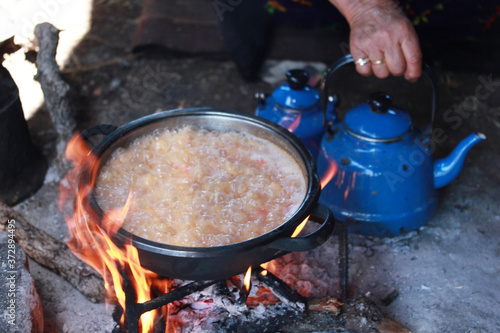 Bulgur pilaf cooked in wood fire. Nomad tent.