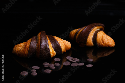 Croissants with chocolate. Homemade pastries, croissants decorated with chocolate.