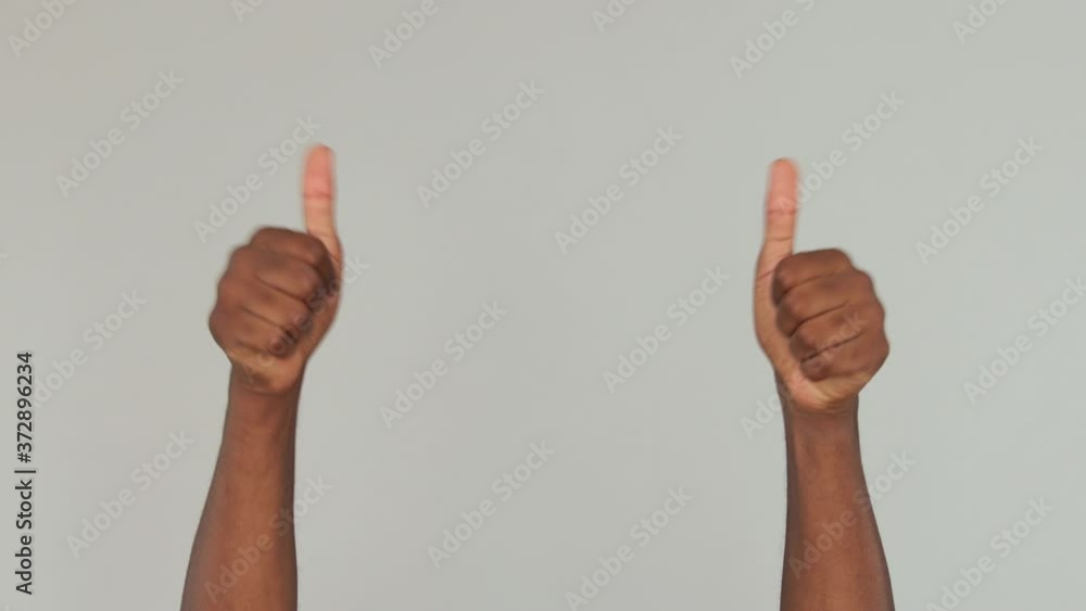 Cropped close up african american man guy male applause cheering clapping hands thumbs up isolated on gray color background in studio. Copy space advertisement place for text Advertising area mock up Cropped close up african american man guy male applause cheering clapping hands thumbs up isolated on gray color background in studio. Copy space advertisement place for text Advertising area mock up