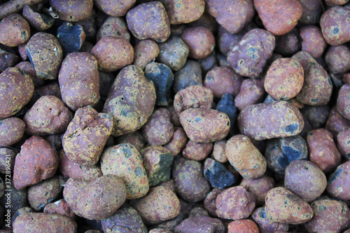 Stone gravel texture background on the ground. Stones pattern close up top view, rough rock pebble background wallpaper