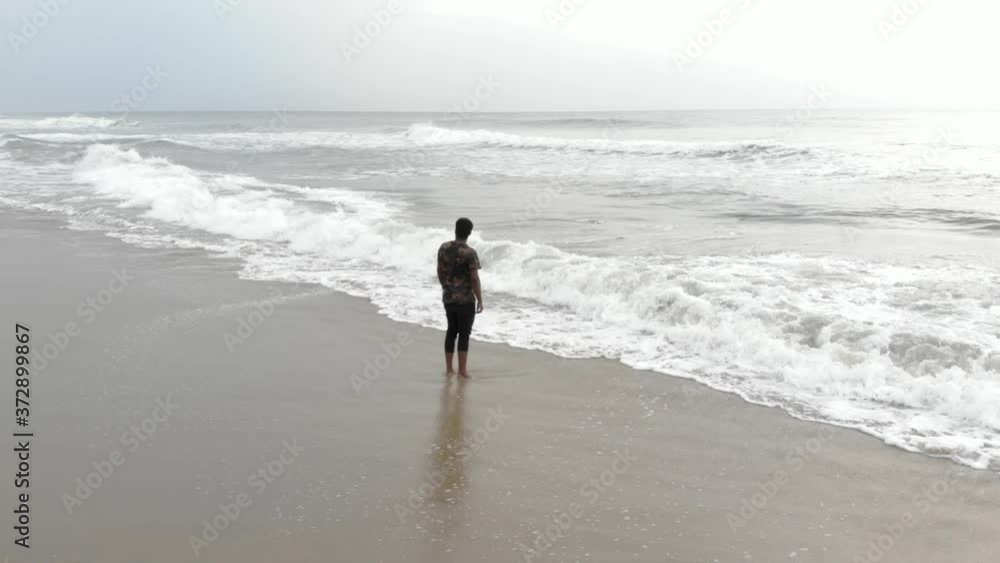 Lonely Indian Young Man Standing in the Beach Lonely Indian Young Man Standing in the Beach