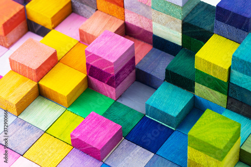 Spectrum of stacked multi-colored wooden blocks. Background or cover for something creative  diverse  expanding  rising or growing. 