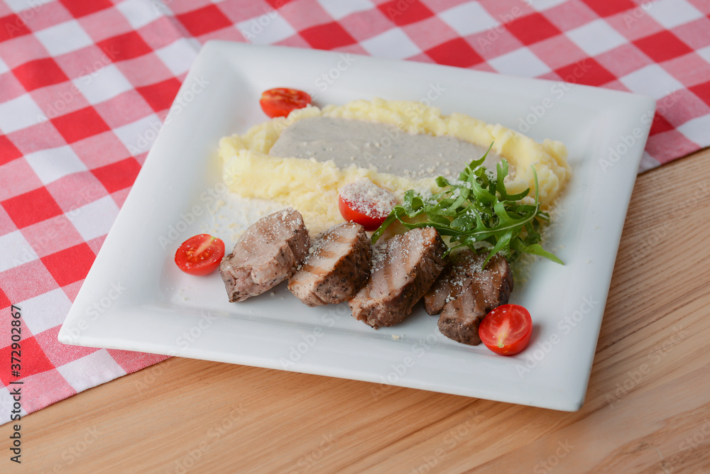 Mashed potatoes with gravy, meat, fresh greenery and raw organic vegetables. Mashed potatoes with gravy, meat, fresh greenery and raw organic vegetables.