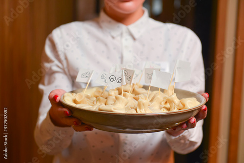 Waiter serves georgian meat dumplings called khinkali. Delicious dinner, Georgian cuisine. photo