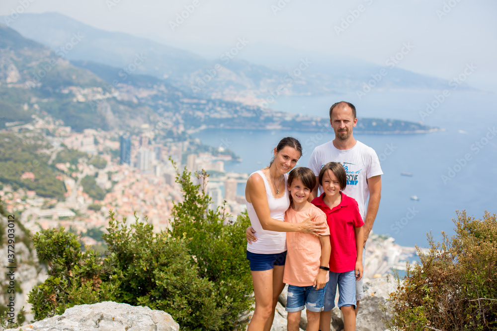 Family, looking at the view of Monaco from La Turbie, standing on top of the rocks in the valley Family, looking at the view of Monaco from La Turbie, standing on top of the rocks in the valley