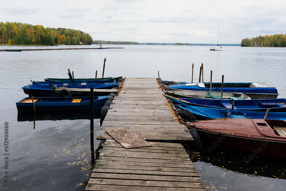Moored boats in the autumn lake