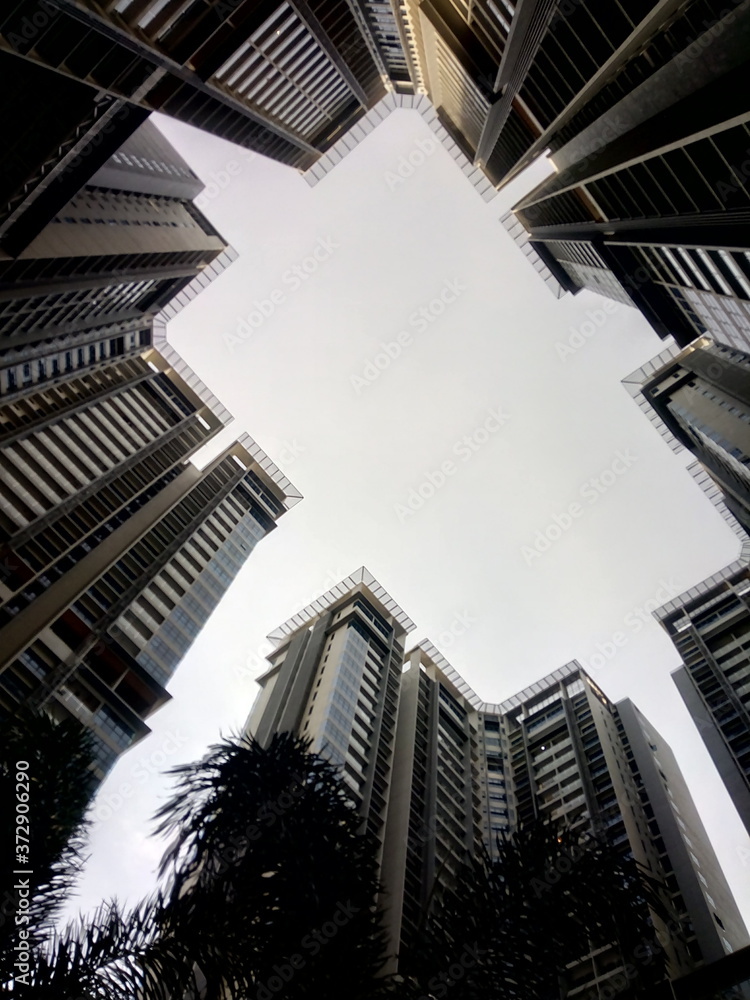 View looking up through modern apartment blocks 
