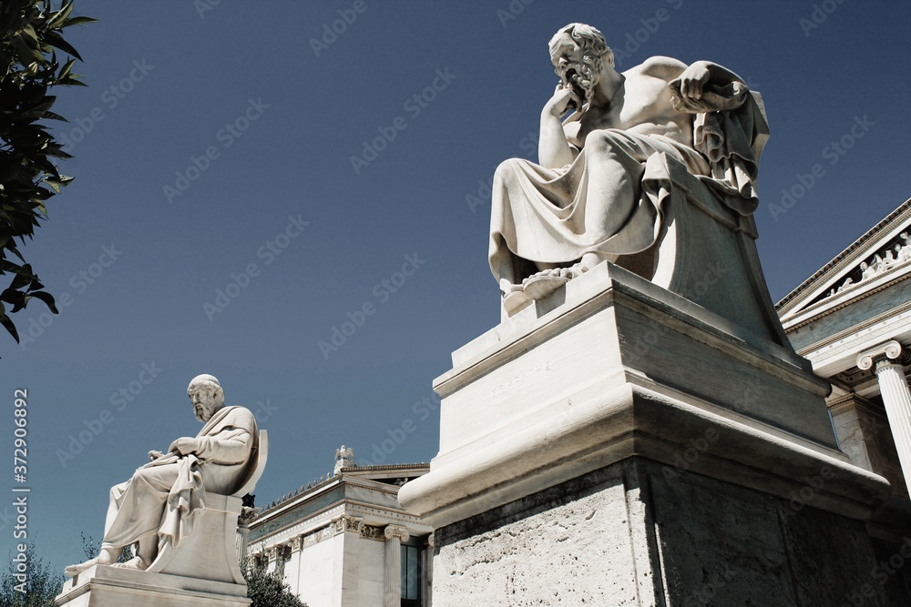 View of the statues of the ancient Greek philosophers Plato and Socrates in Athens, Greece, June 17 2020.