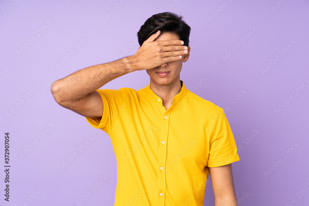 Man over isolated purple background covering eyes by hands. Do not want to see something Man over isolated purple background covering eyes by hands. Do not want to see something