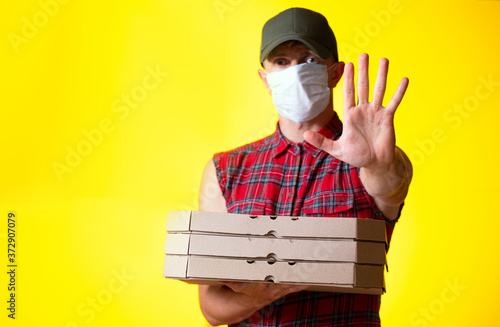 Young caucasian Handsome Pizza delivery man holding pizza boxes 
 photo