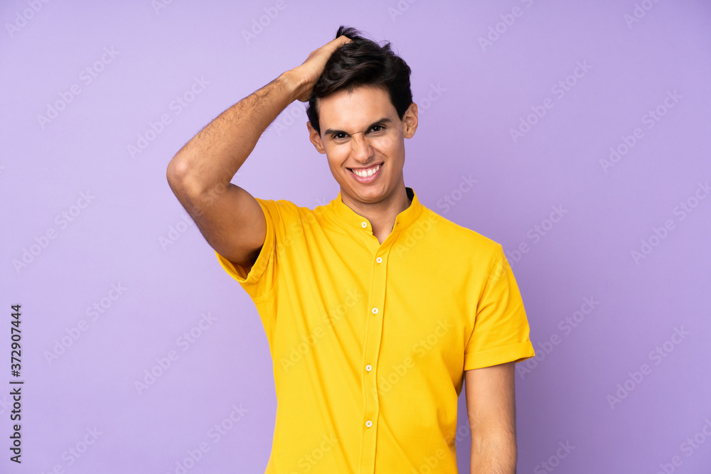 Man over isolated purple background with an expression of frustration and not understanding Man over isolated purple background with an expression of frustration and not understanding