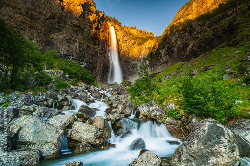 Fototapeta Naklejka Na Ścianę i Meble -  Beautiful Norwegian waterfall at sunset