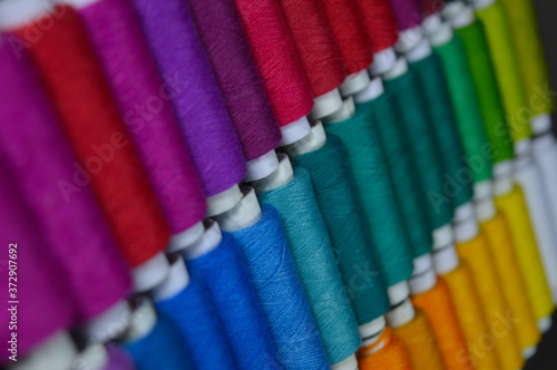 colourful thread rolls arranged in a box
