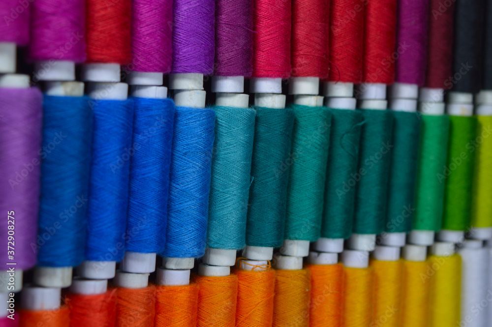 colourful thread rolls arranged in a box colourful thread rolls arranged in a box
