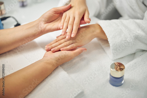 Woman visiting spa salon for natural manicure