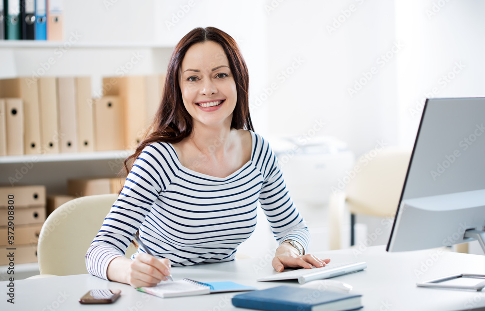 Portrait of a business woman at workplace in an office
