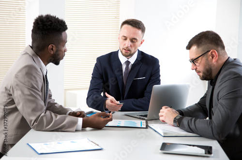 Wallpaper Mural International group of business people working and communicating sitting near office desk. Torontodigital.ca