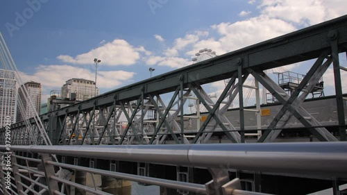 Commuter train crossing hungerford bridge london. City infrastructure. photo