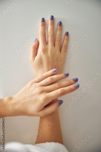 Pretty female hands with fashionable bright manicure