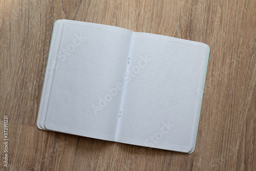 Obraz na plátně empty text book isolated on wooden background, template for planning, notes or d