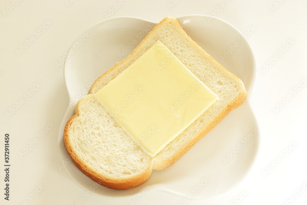 Sliced cheese on bread for breakfast